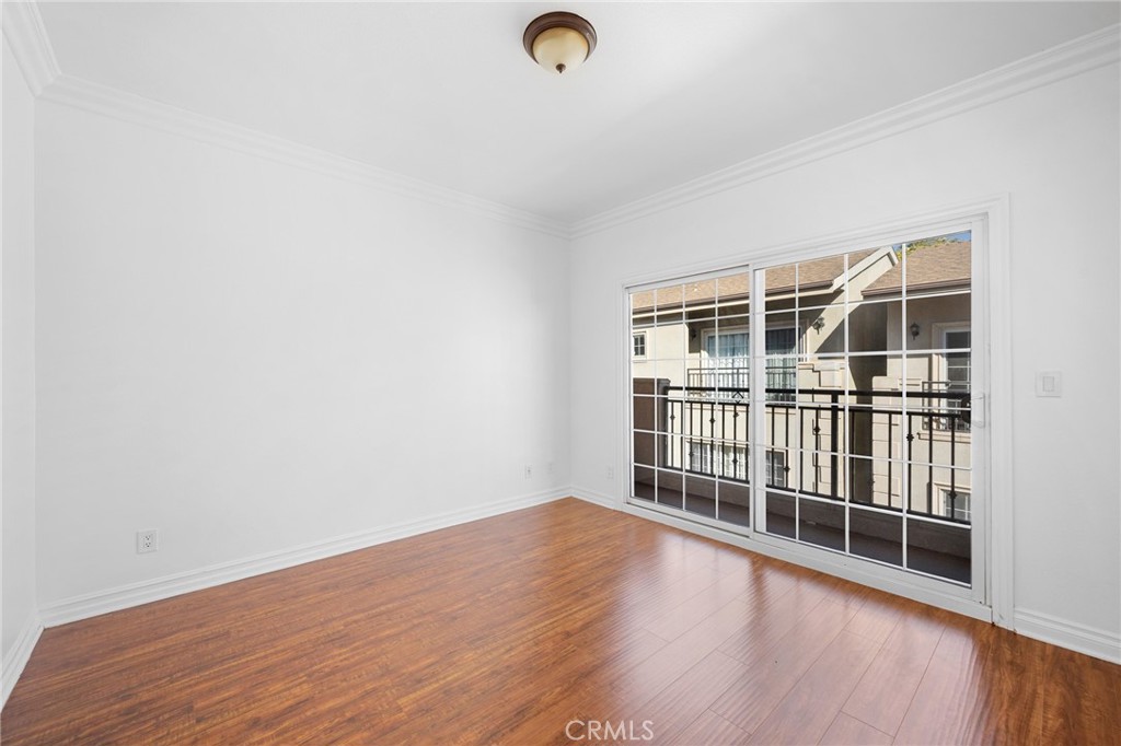 6831 Valmont Street, Unit 1 Tujunga, CA 91042 - Photo 14 of 30 an empty room with wooden floor and windows
