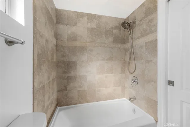 a bathroom with a shower and a toilet