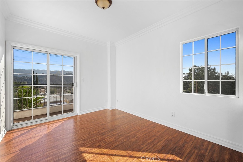 6831 Valmont Street, Unit 1 Tujunga, CA 91042 - Photo 24 of 30 a view of wooden floor and windows in a room