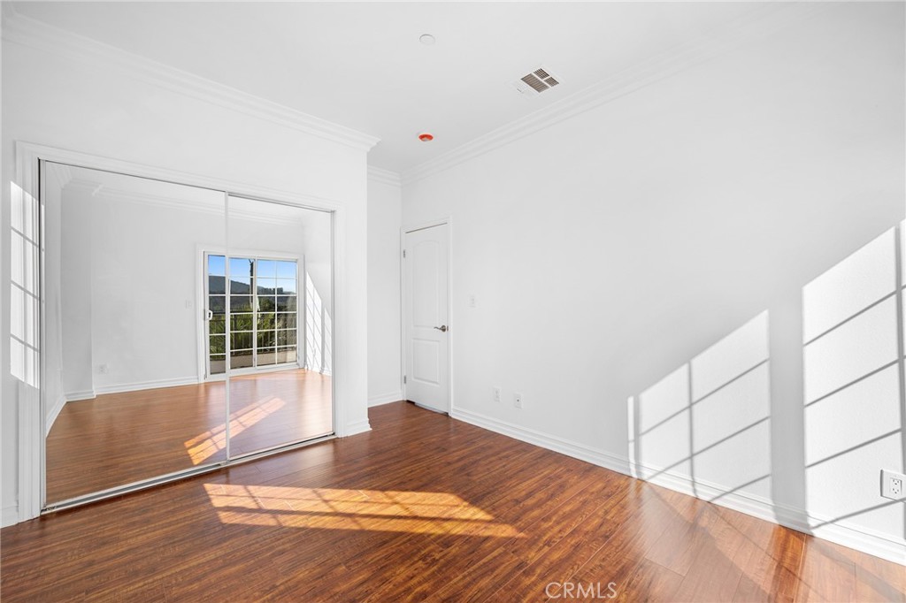 6831 Valmont Street, Unit 1 Tujunga, CA 91042 - Photo 26 of 30 a view of wooden floor and windows in a room