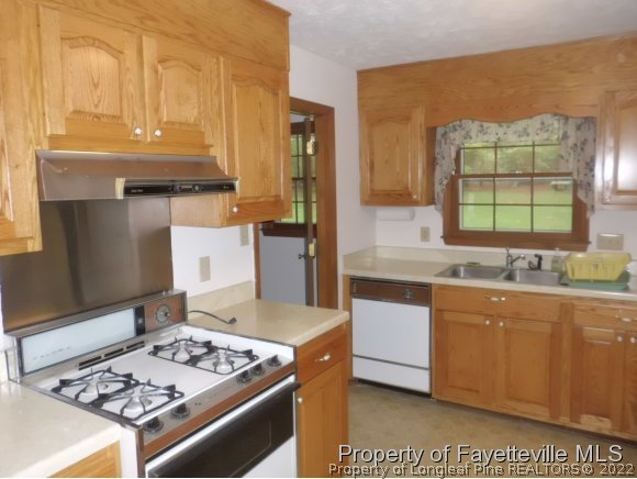 400 Myra Road Raeford, NC 28376 - Photo 11 of 24 a kitchen with stainless steel appliances granite countertop a stove a sink and a microwave