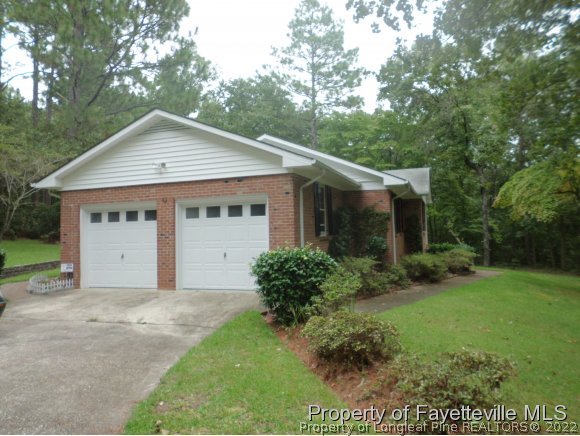 400 Myra Road Raeford, NC 28376 - Photo 21 of 24 a view of a house with yard and a garden