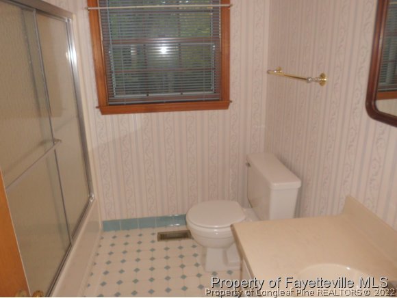 400 Myra Road Raeford, NC 28376 - Photo 5 of 24 a bathroom with a toilet and a shower