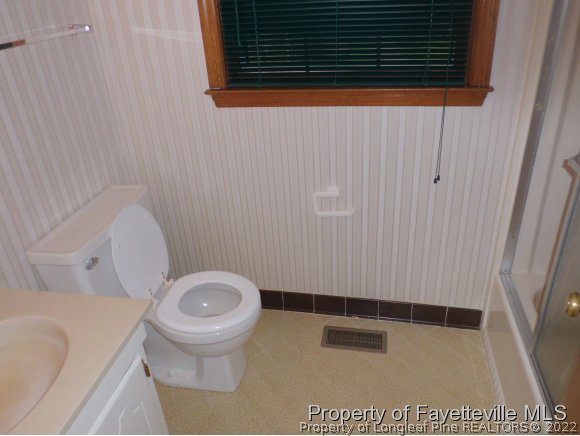 400 Myra Road Raeford, NC 28376 - Photo 7 of 24 a bathroom with a toilet and a shower curtain