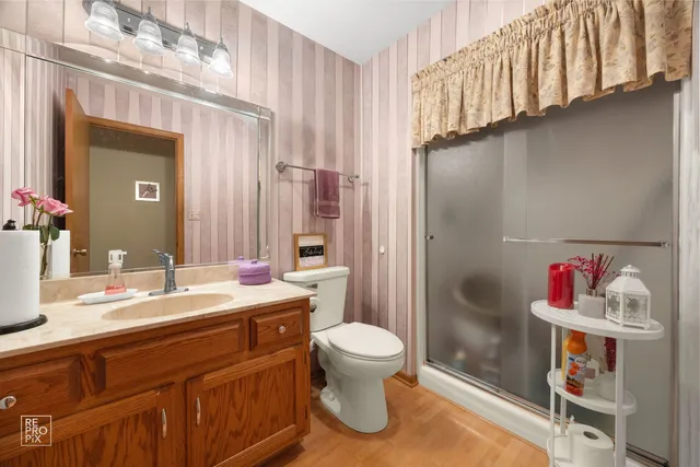 a bathroom with a sink toilet and shower