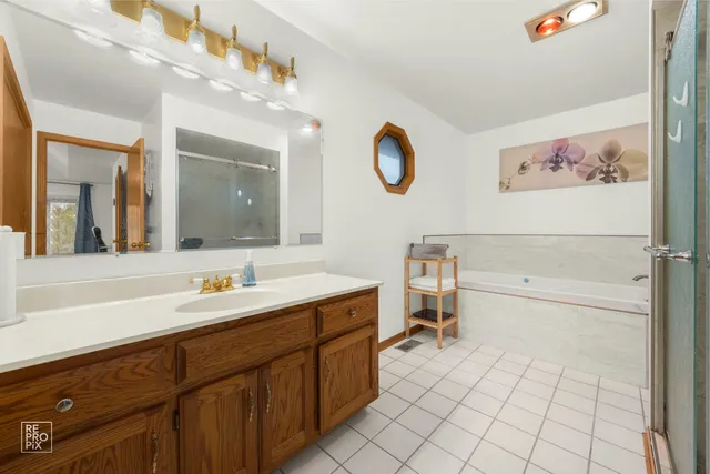 a spacious bathroom with a sink mirror and toilet