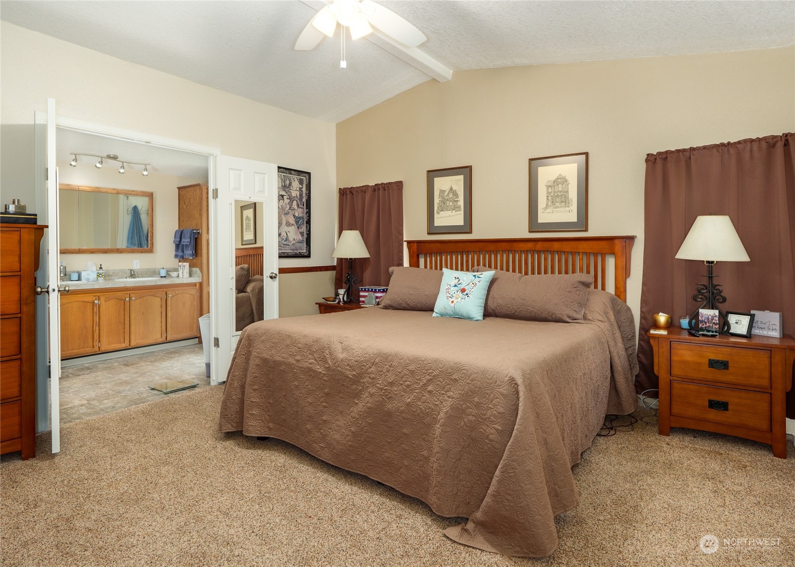 74 Miles Road Port Angeles, WA 98362 - Photo 15 of 40 a bedroom with a bed and a chandelier