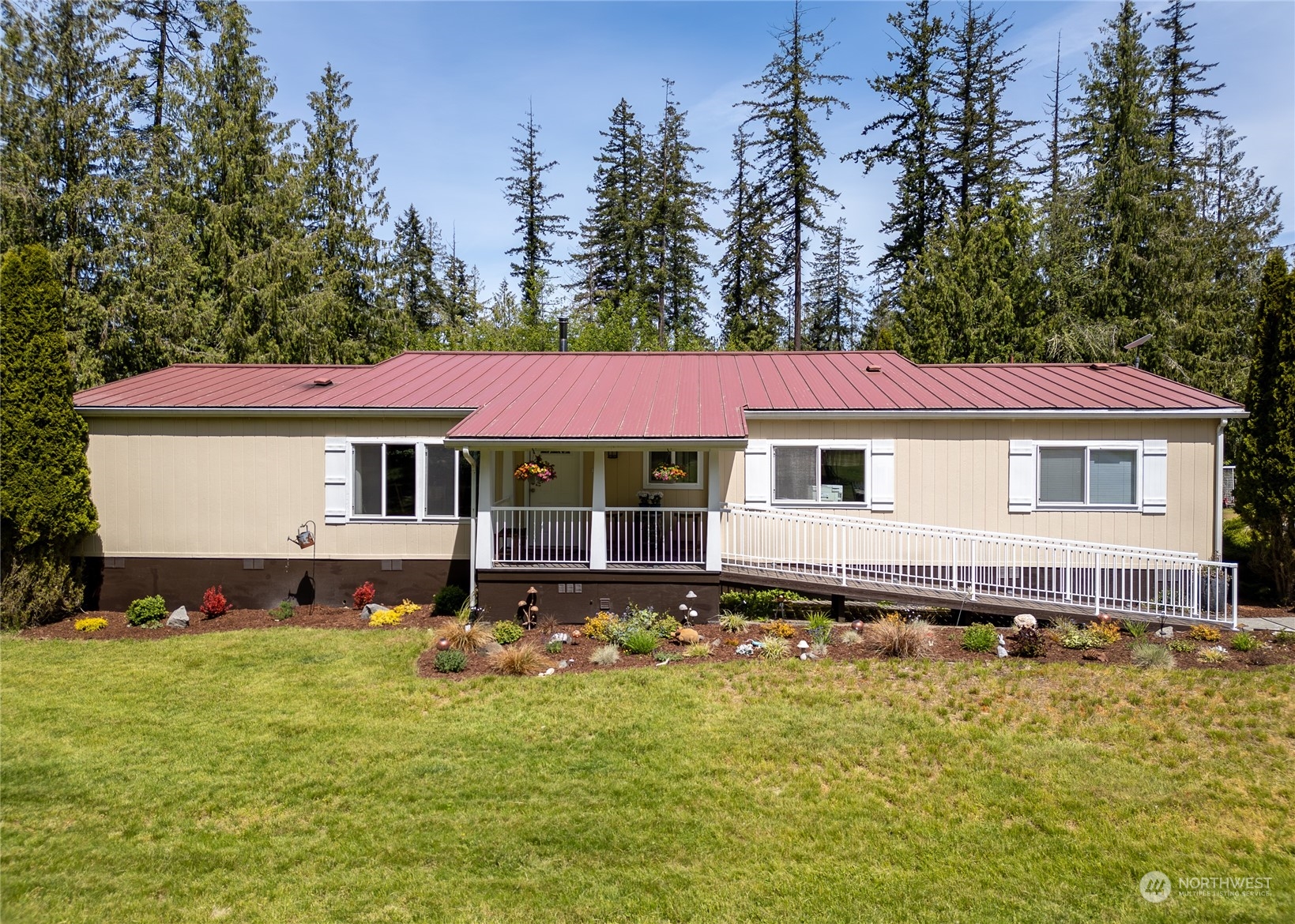 74 Miles Road Port Angeles, WA 98362 - Photo 3 of 40 a front view of a house with a garden and swimming pool