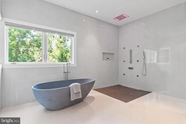 a living room with furniture and a large mirror