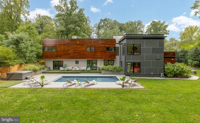 a view of a house with swimming pool and sitting area