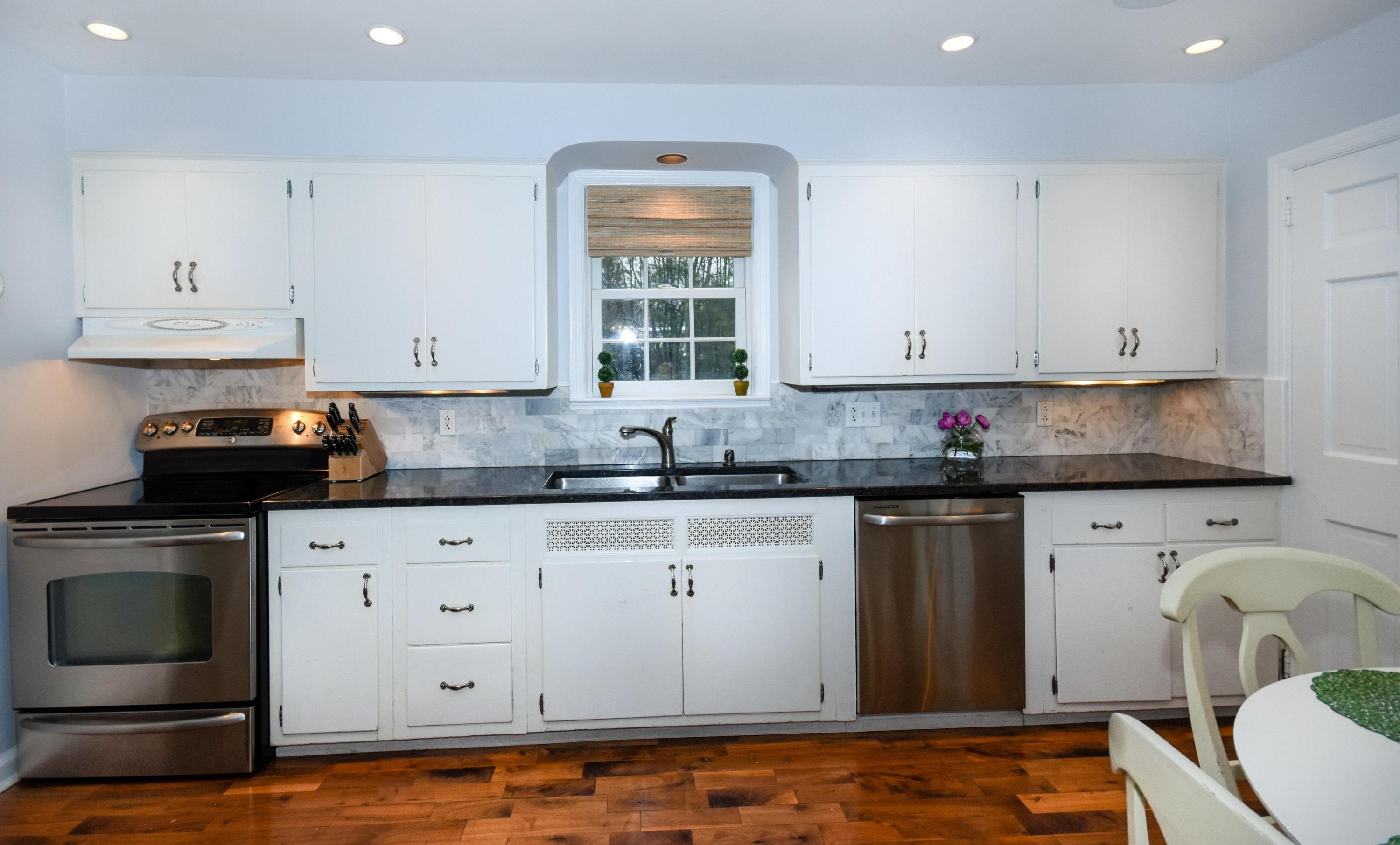 17 Abbey Road Darien, CT 06820 - Photo 11 of 24 a kitchen with granite countertop white cabinets and stainless steel appliances