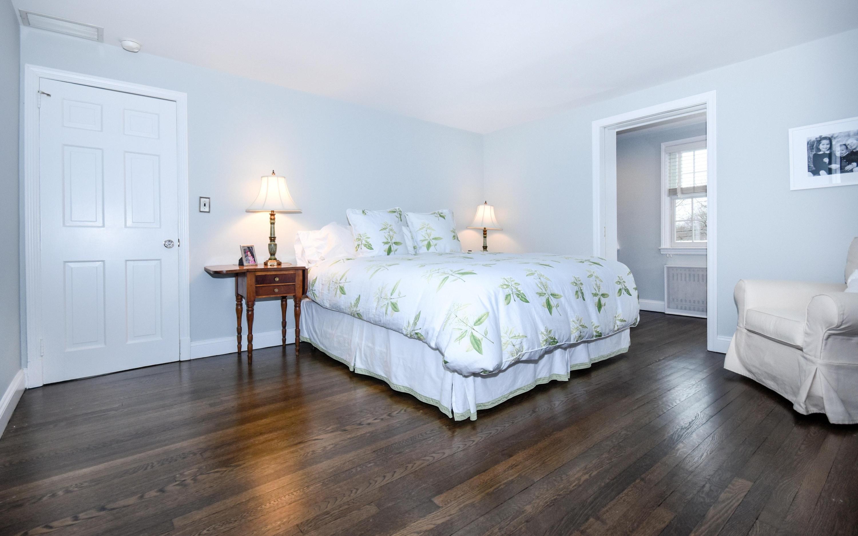 17 Abbey Road Darien, CT 06820 - Photo 12 of 24 a bedroom with a bed and a lamp