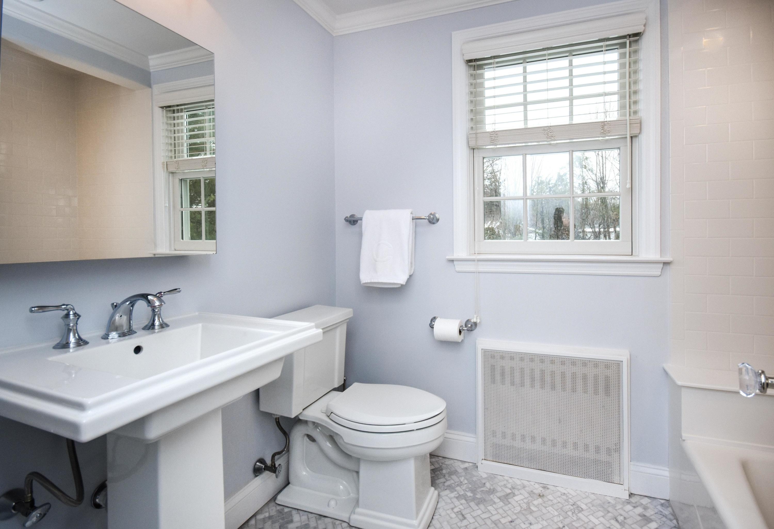 17 Abbey Road Darien, CT 06820 - Photo 18 of 24 a bathroom with a sink a toilet and a window