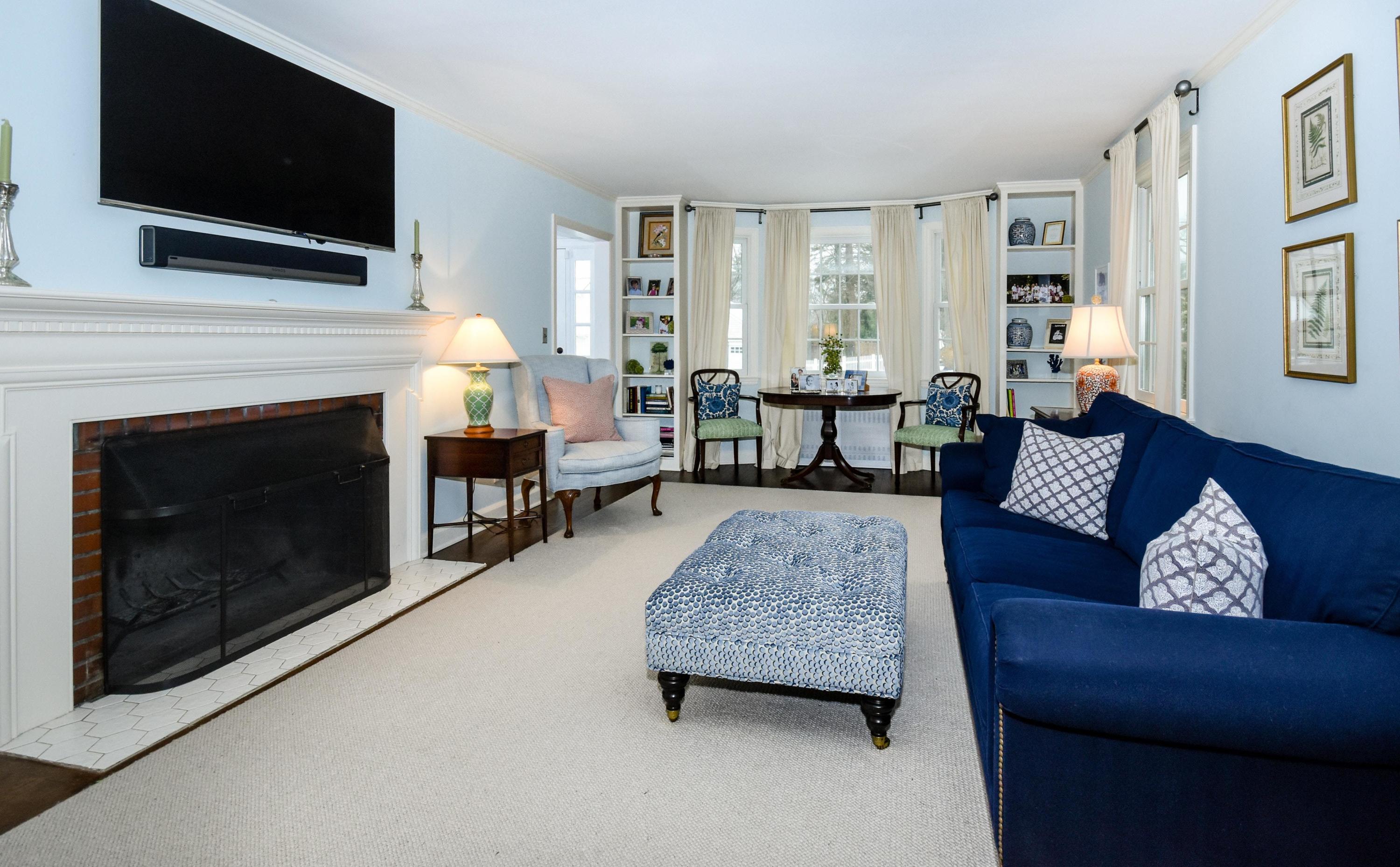 17 Abbey Road Darien, CT 06820 - Photo 4 of 24 a living room with furniture a flat screen tv and a fireplace
