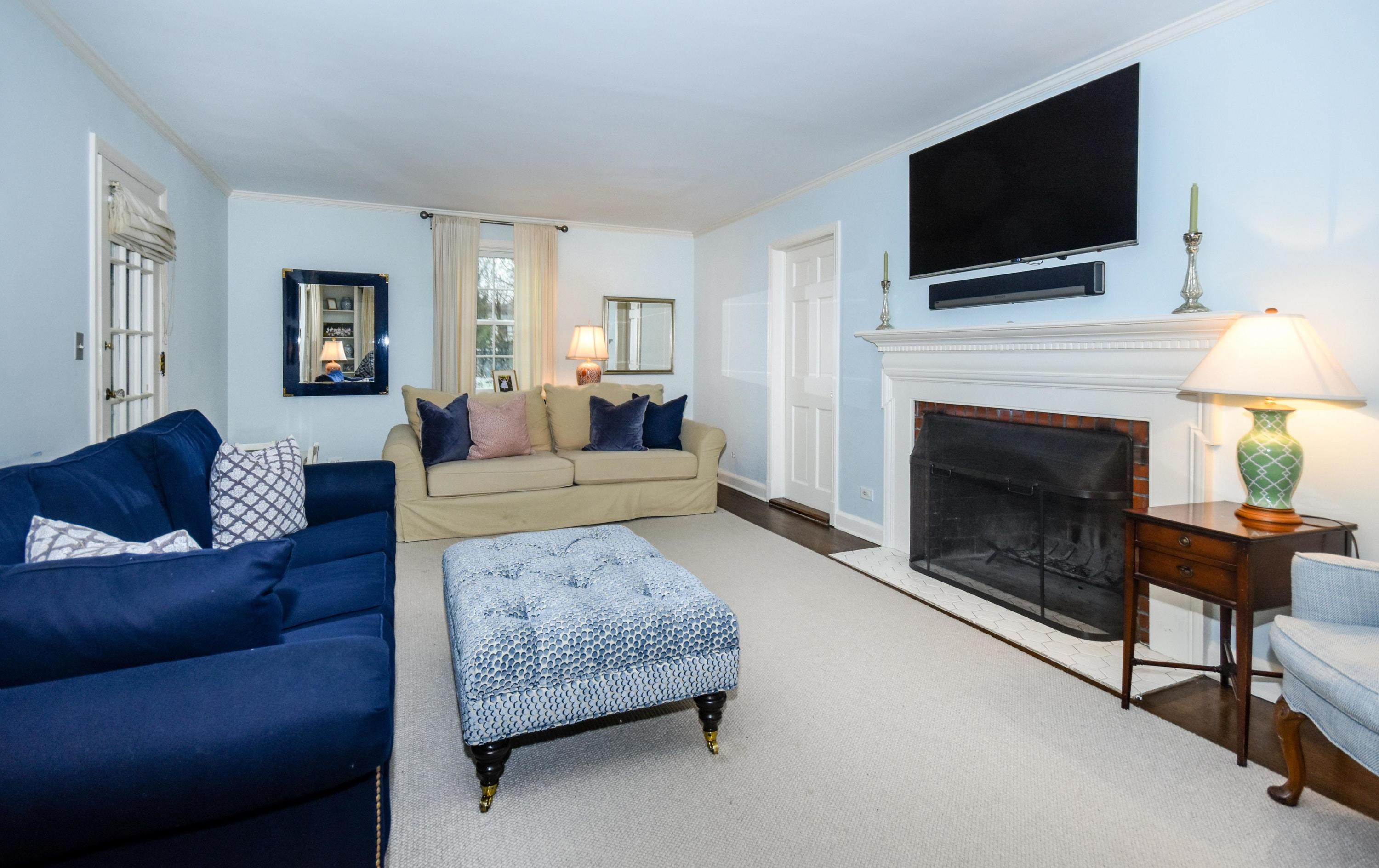 17 Abbey Road Darien, CT 06820 - Photo 6 of 24 a living room with furniture a flat screen tv and a fireplace
