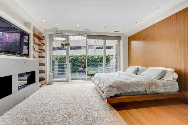 a bedroom with a large bed and a tv