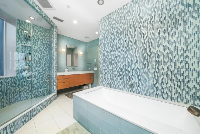 a bathroom with a bathtub and shower