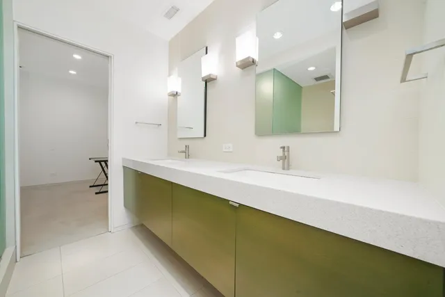 a bathroom with a double vanity sink and a mirror