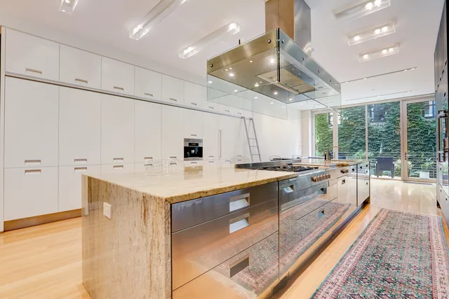 a large white kitchen with a large window