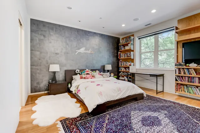 a bed room with a bed and a book shelf