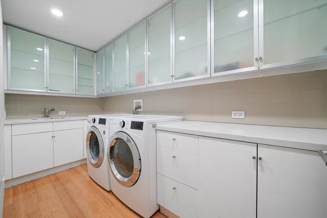 a view of a storage and utility room with washer and dryer