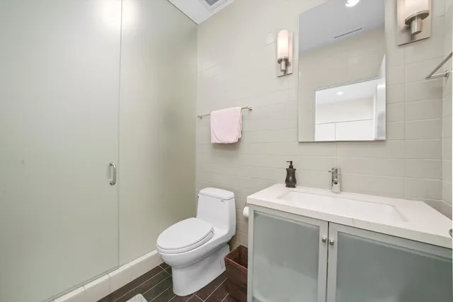 a bathroom with a toilet sink and mirror