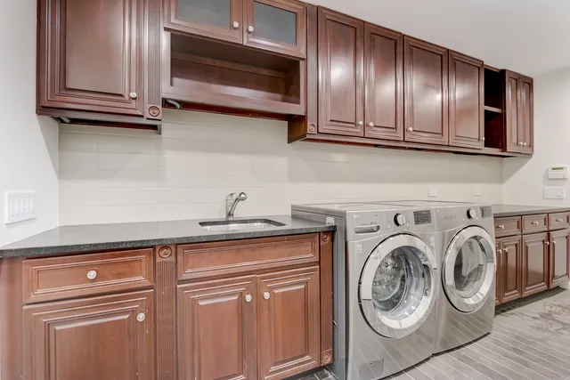 a utility room with multiple dryer and washer
