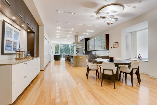 a large kitchen with a table and chairs