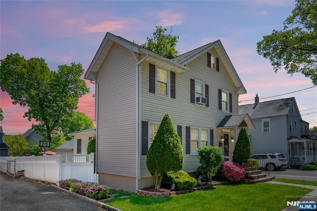 690 Garden Street Maywood, NJ 07607 - Photo 3 of 49 a front view of a house with a garden and plants