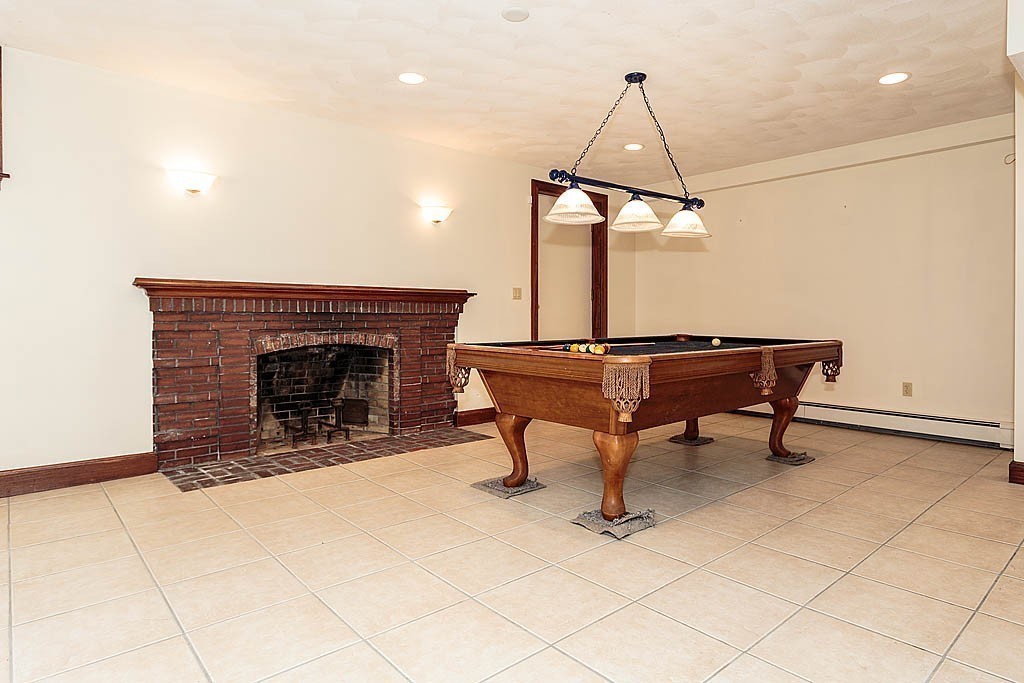 107 Rutledge Road Belmont, MA 02478 - Photo 15 of 16 a living room with furniture a piano and a fireplace
