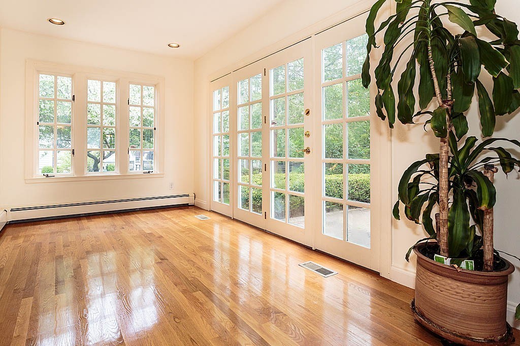 107 Rutledge Road Belmont, MA 02478 - Photo 4 of 16 a view of an empty room with a window and wooden floor