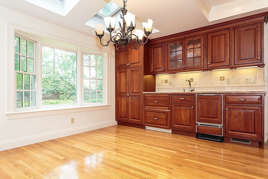 107 Rutledge Road Belmont, MA 02478 - Photo 9 of 16 a room with a dresser and chandelier