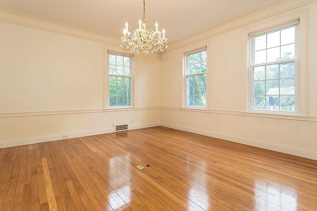 107 Rutledge Road Belmont, MA 02478 - Photo 10 of 16 a view of an empty room with wooden floor and a window