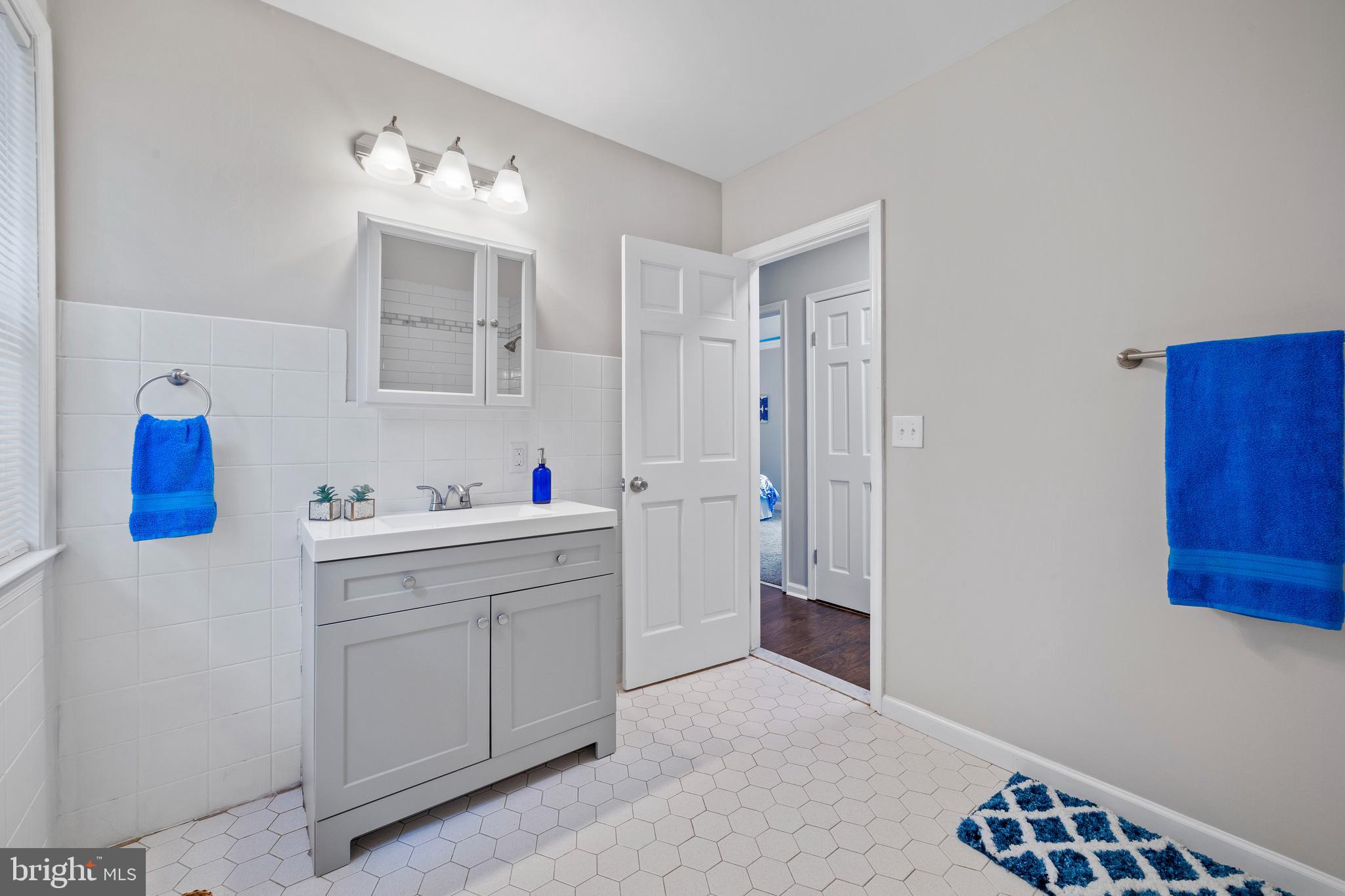 606 4th Street Riverside, NJ 08075 - Photo 14 of 37 a bathroom with a sink vanity and mirror