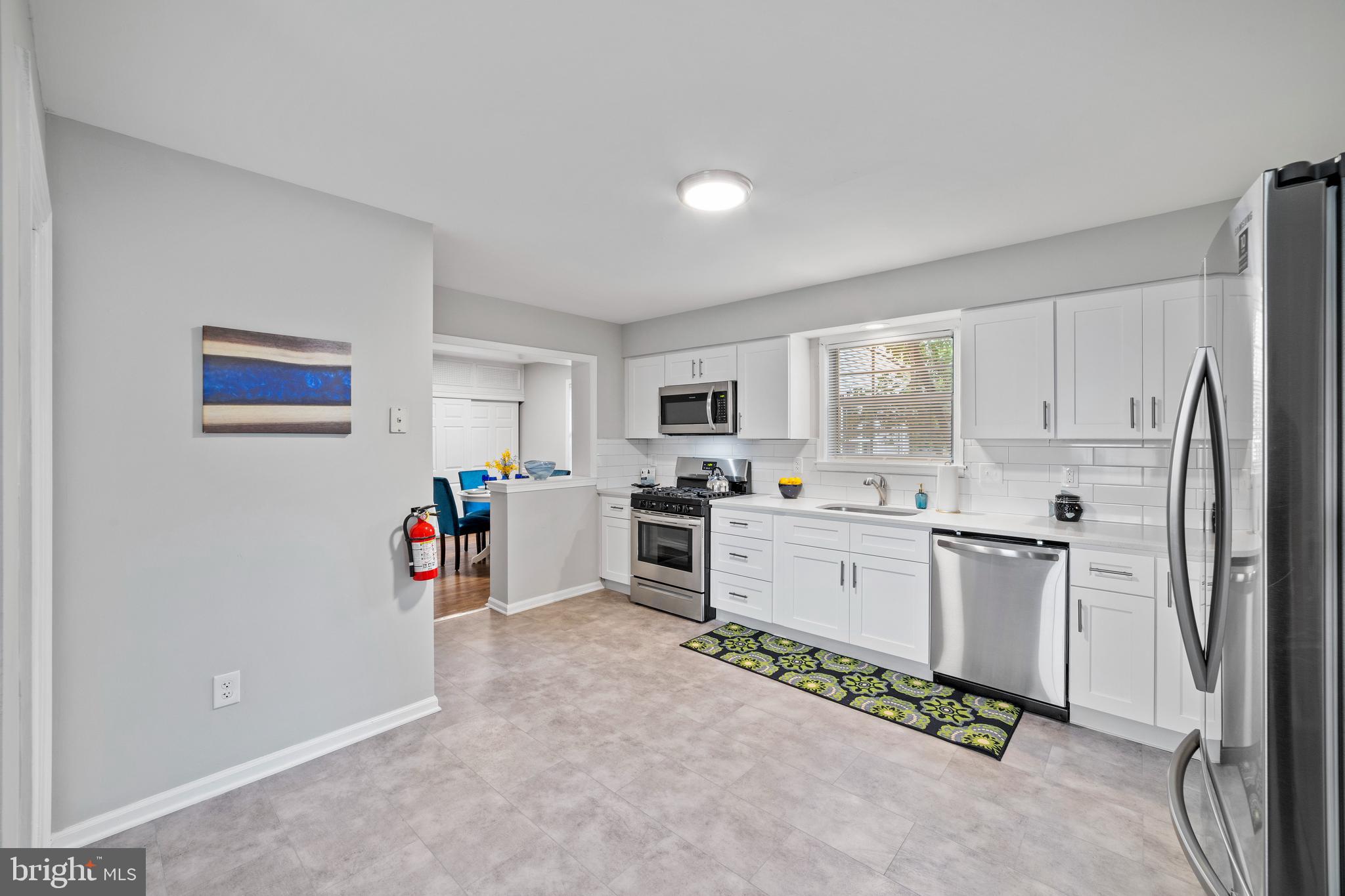 606 4th Street Riverside, NJ 08075 - Photo 6 of 37 a kitchen with white cabinets and appliances