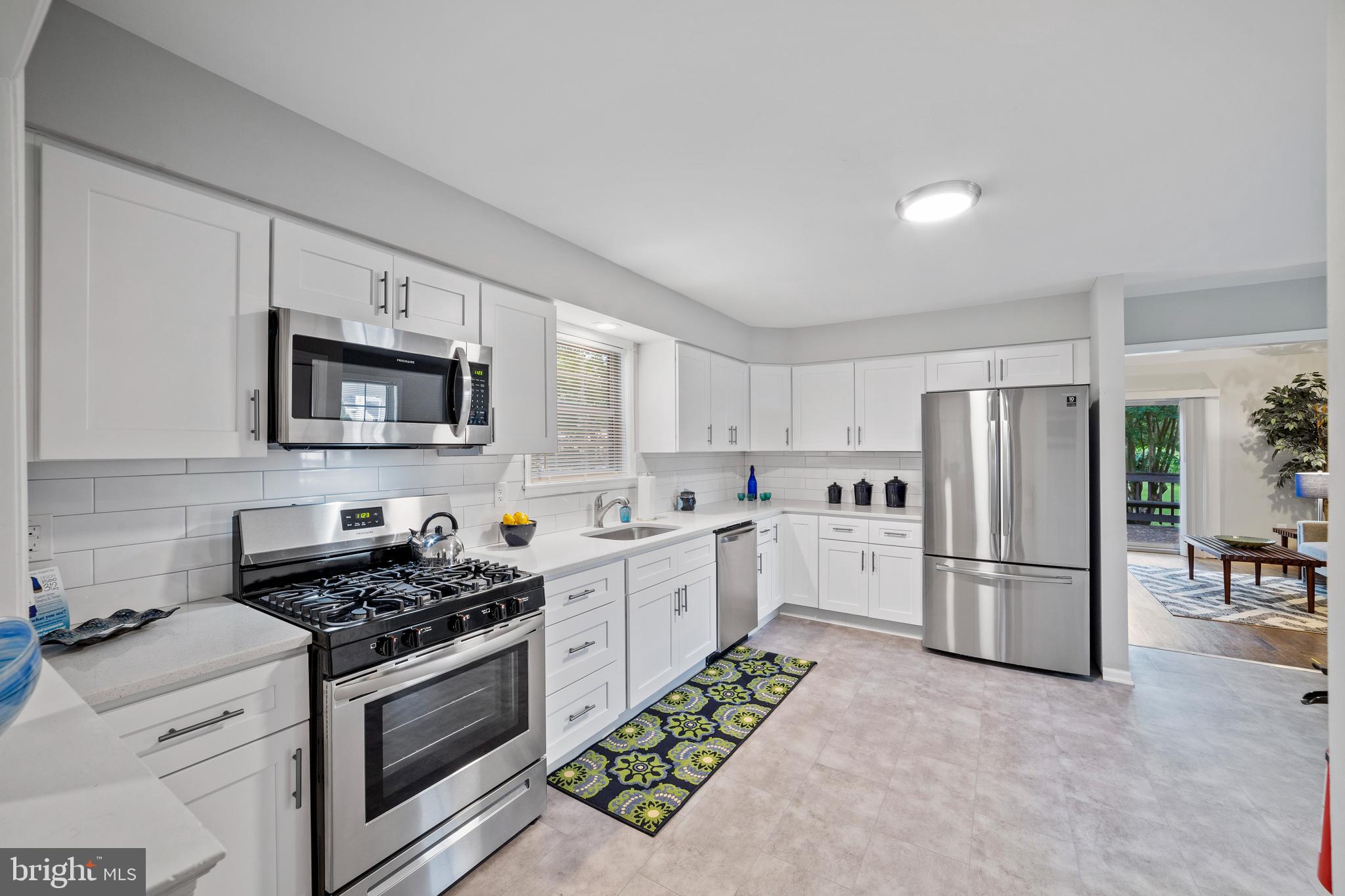 606 4th Street Riverside, NJ 08075 - Photo 8 of 37 a kitchen with stainless steel appliances granite countertop a refrigerator stove top oven and sink