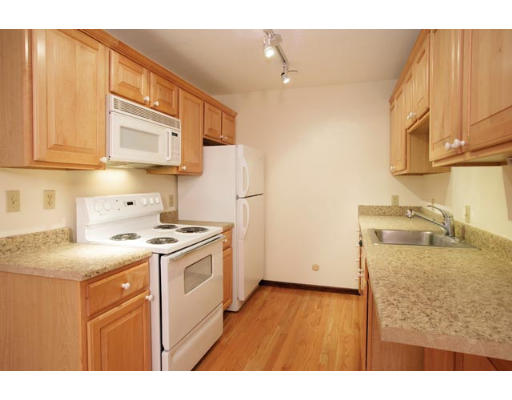 94 Beaconsfield Road, Unit 203 Brookline, MA 02445 - Photo 3 of 5 a kitchen with a stove a sink and a refrigerator