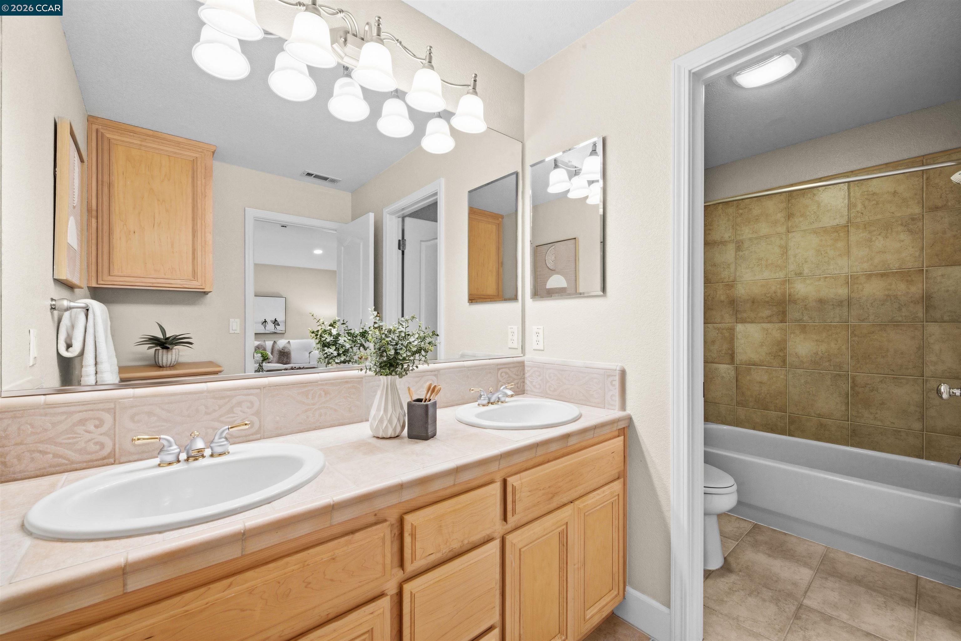 5260 Hiddencrest Court Concord, CA 94521 - Photo 48 of 87 a bathroom with a sink a toilet and a mirror