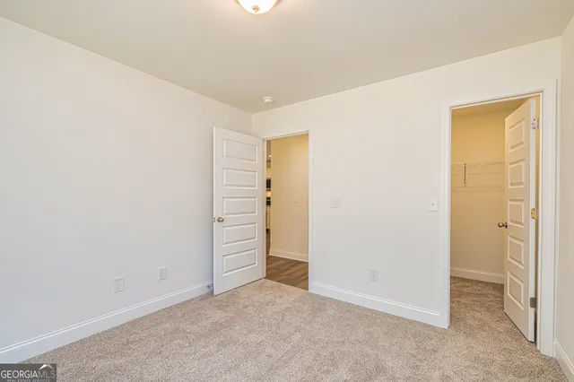 a view of an empty room with a fireplace and a window