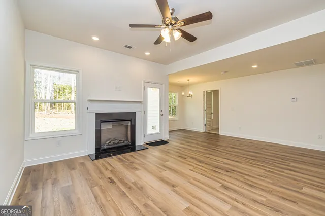 an empty room with closet and ceiling fan