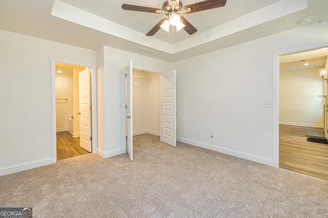 a bathroom with a granite countertop double vanity sink a mirror and a shower