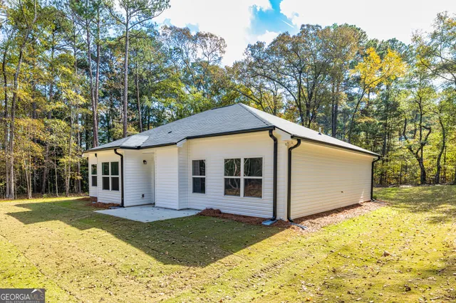 a view of a house with a yard and sitting area