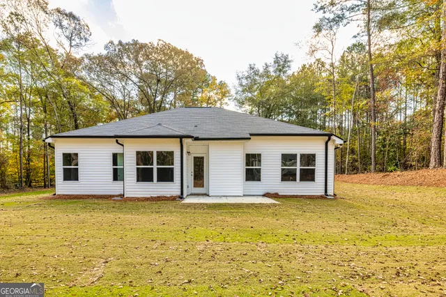 a swimming pool with trees in front of it