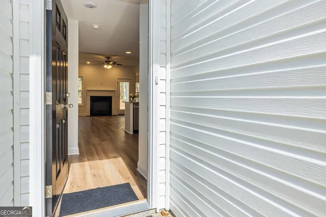 a kitchen with a sink cabinets and wooden floor