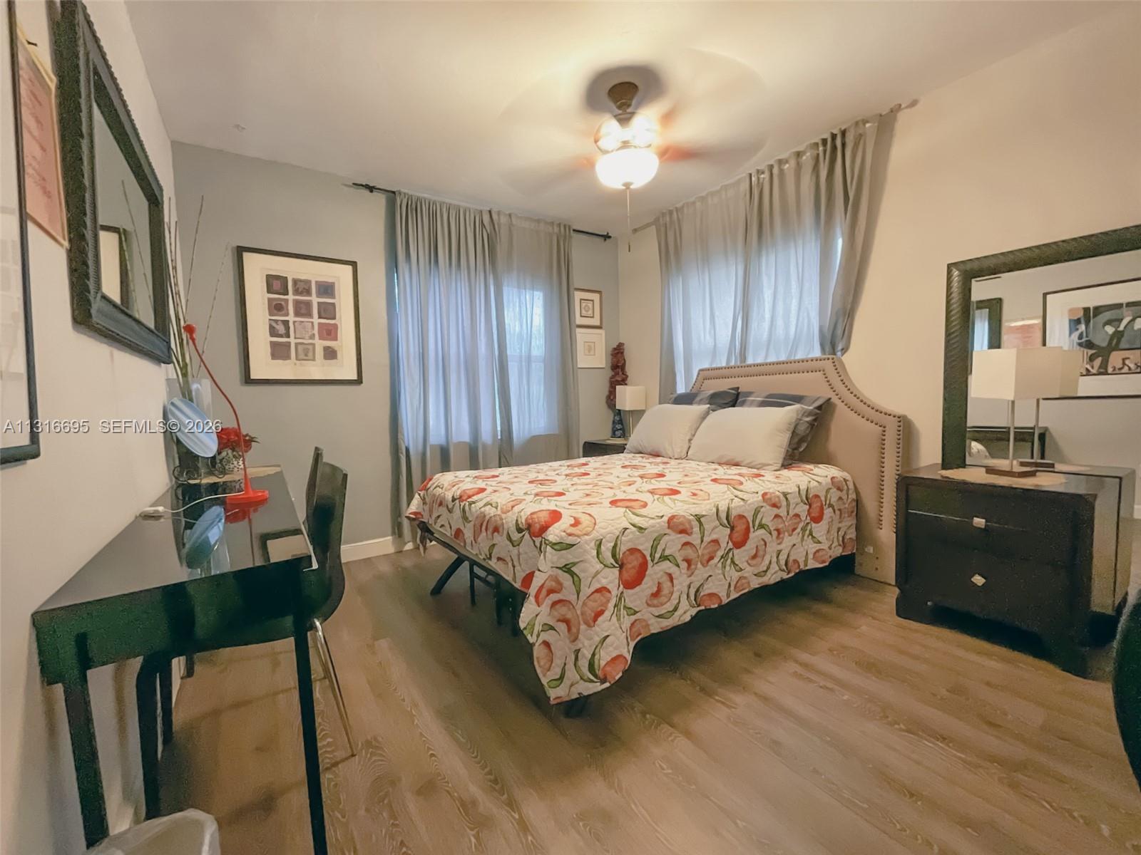 3682 Southwest 26th Street, Unit 2 Miami, FL 33133 - Photo 14 of 23 a bedroom with a bed and a dresser in it