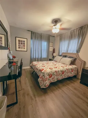 a bedroom with a bed a table and chair
