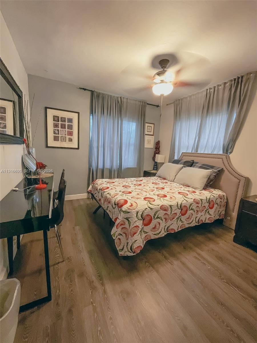 3682 Southwest 26th Street, Unit 2 Miami, FL 33133 - Photo 15 of 23 a bedroom with a bed a table and chair