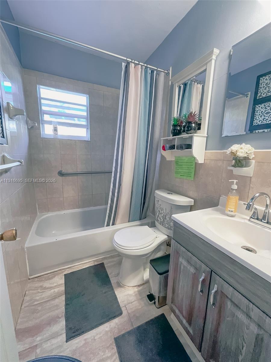 3682 Southwest 26th Street, Unit 2 Miami, FL 33133 - Photo 18 of 23 a bathroom with a sink a toilet and shower