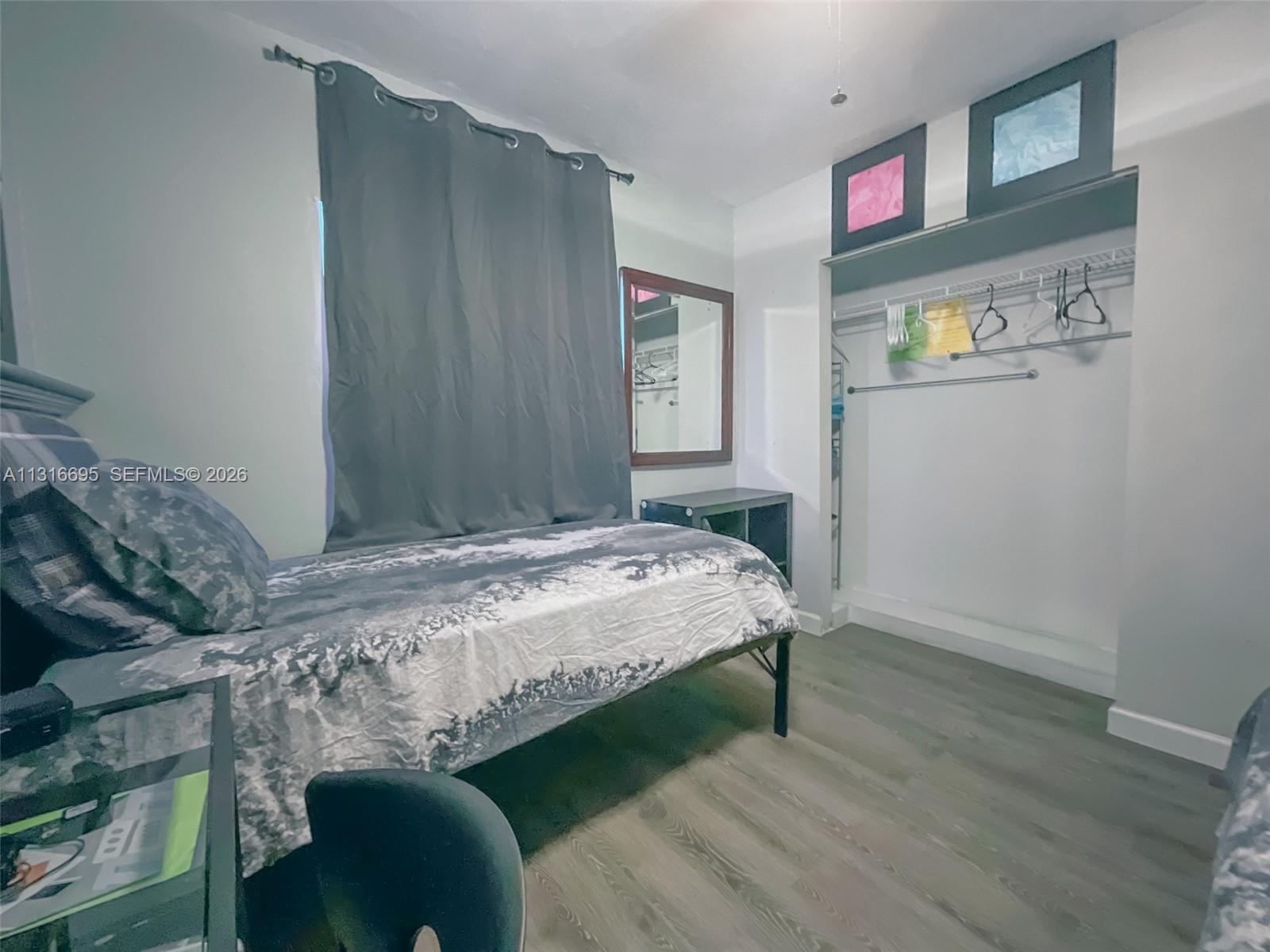 3682 Southwest 26th Street, Unit 2 Miami, FL 33133 - Photo 19 of 23 a bedroom with a bed and cabinets