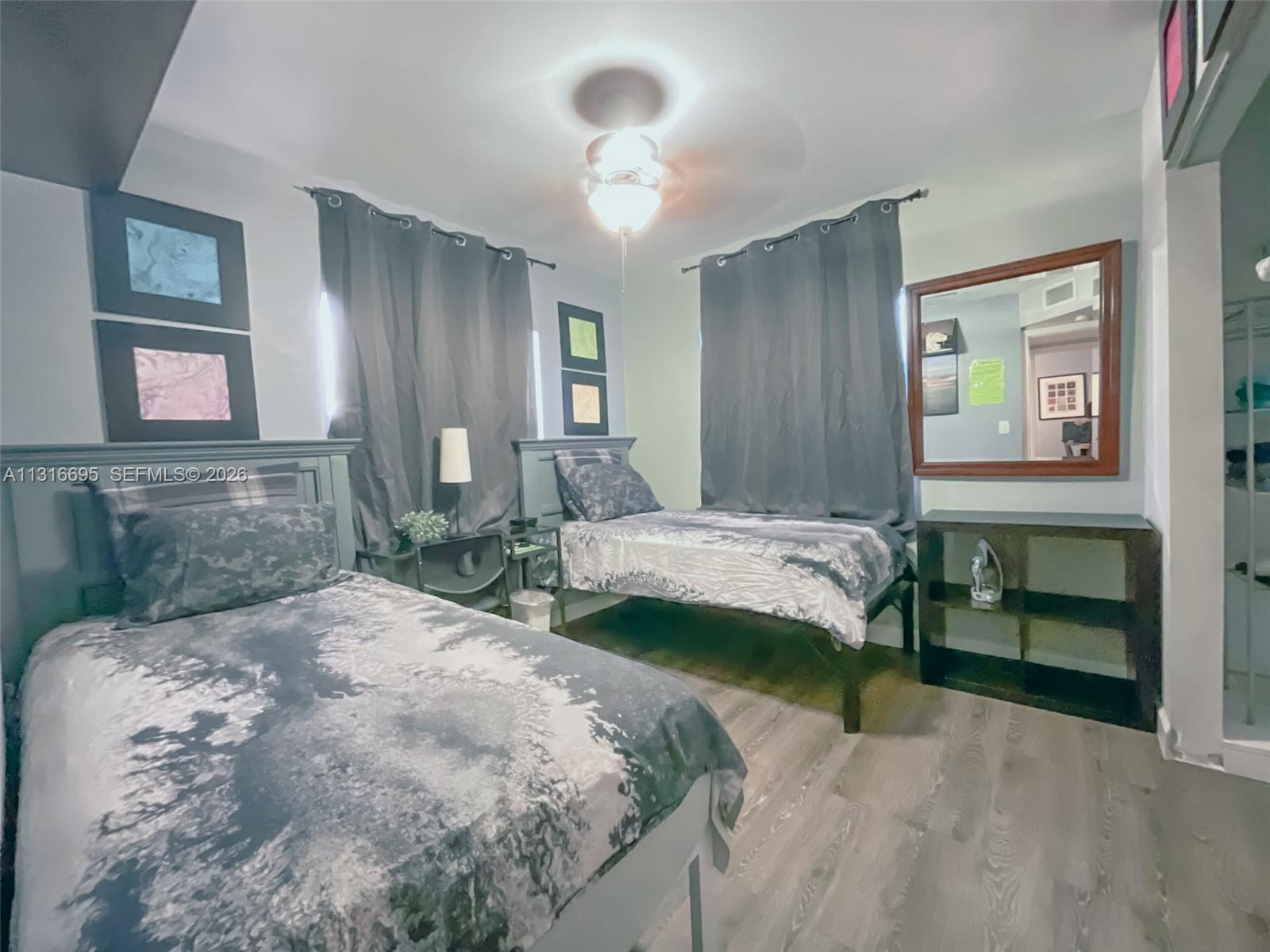 3682 Southwest 26th Street, Unit 2 Miami, FL 33133 - Photo 21 of 23 a bedroom with a bed and a chandelier